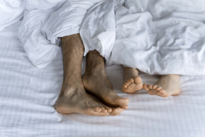 This is an image of feet underneath covers. This image could depict a family who has gone to sex therapy in atlanta, ga. get started with a sex therapist in atlanta, ga today. 30518 | 30519
