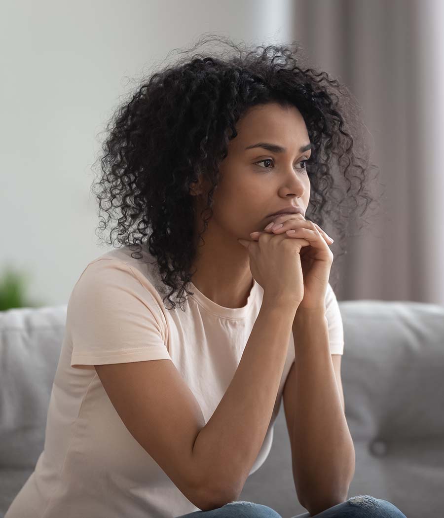 Image of woman with her hands pressed to her chin. This image depicts how one could benefit from meeting with a marriage counselor. If you are considering starting Christian marriage counseling in Atlanta, GA, reach out to us. | 30518 | 30519