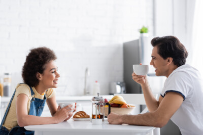 Image of couple looking happy over breakfast. This couple could have recently finished sex therapy in Atlanta, GA. Meet with a Christian sex therapist to see how it could help you, too! | 30041 | 30043