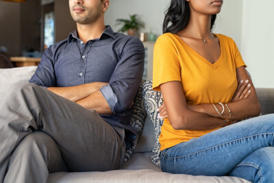 Image of a couple sitting away from each other. This couple could be in need of affair counseling in atlanta, ga. meet with an infidelity therapist in atlanta, ga today! 30518 | 30519