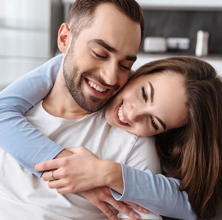 Image of a couple hugging each other and smiling. This image could depict a couple who has recently gone through premarital counseling with a Christian marriage counselor in Atlanta, GA. 30024 | 30097