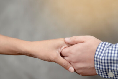 Phot of a masculine looking hand holding a feminine looking hand representing how it IS possible for couples to reconnect and save a marriage after an affair. If you're looking for a couples therapist in Atlanta who specializes in infidelity & affair recover, we can help.