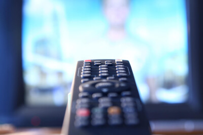 Close up image of a TV and remote. Porn addiction therapy in Atlanta, GA can help your marriage counseling with a sex therapist be more fruitful. Reach out!